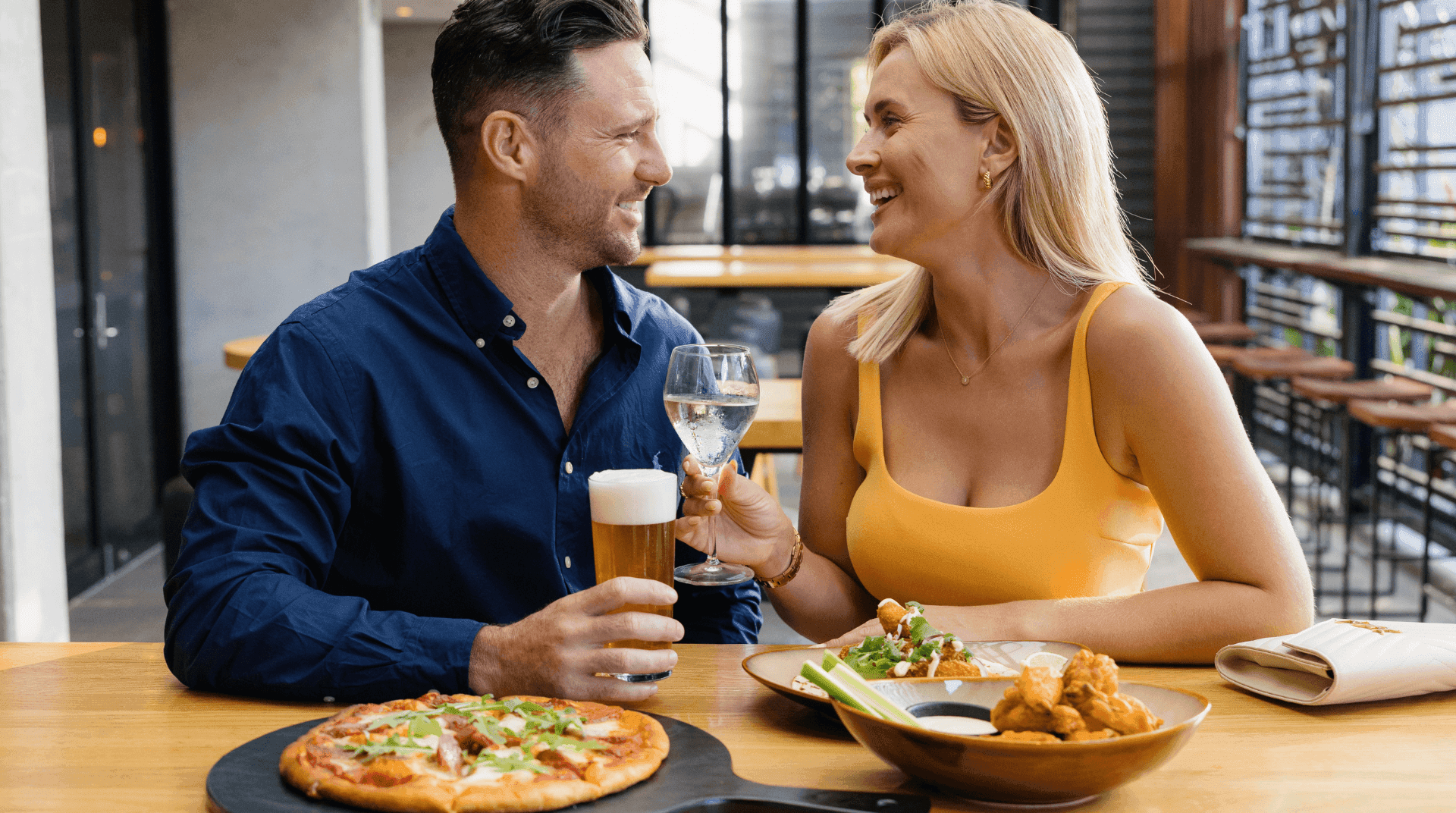 couple-grinning-eating-dinner
